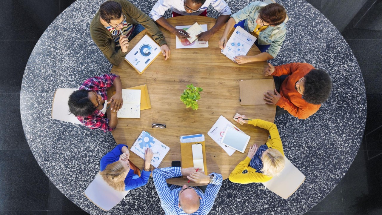 A leadership team aligning different perspectives around one table
